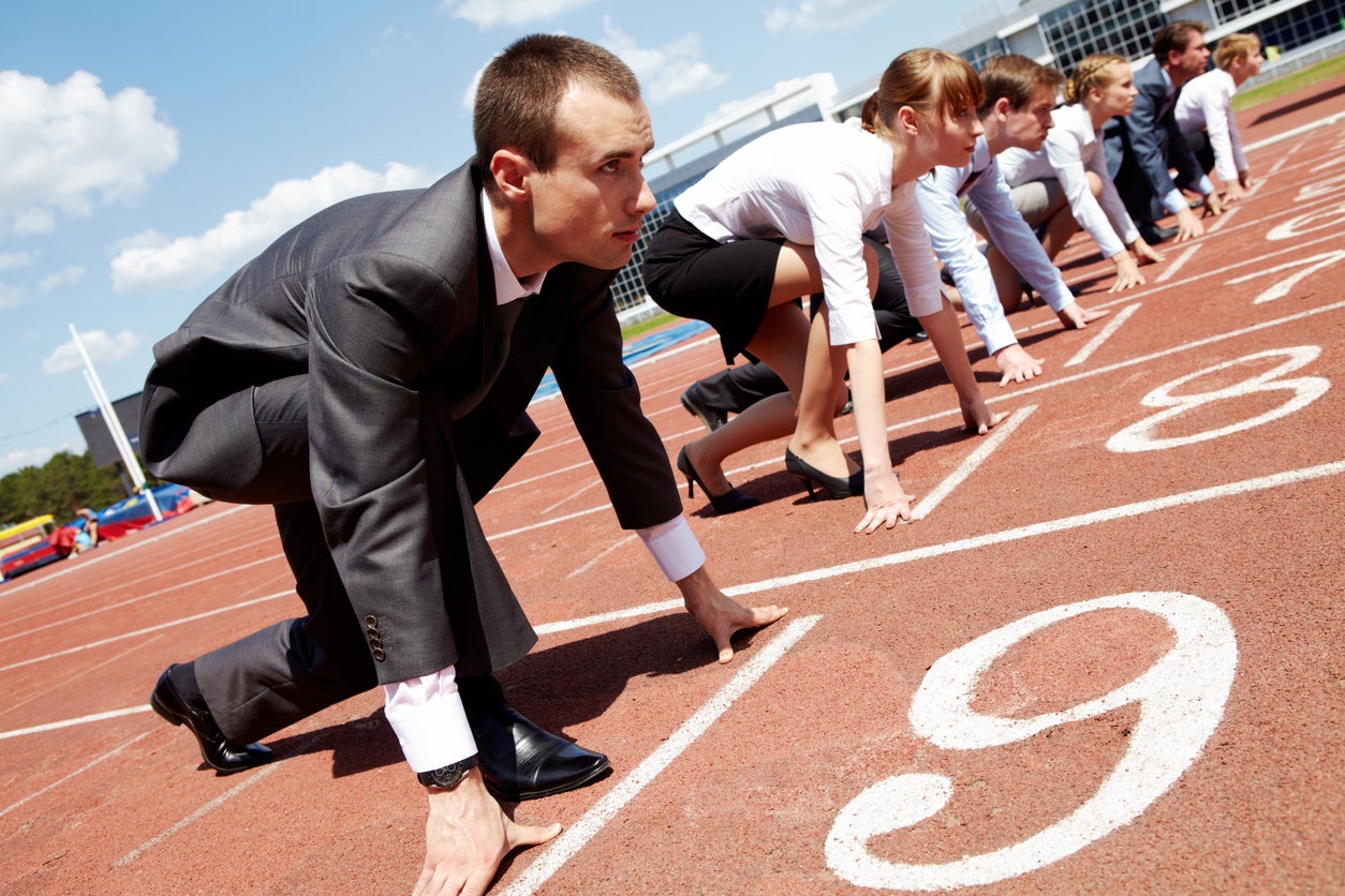 business professionals at the starting line of a track