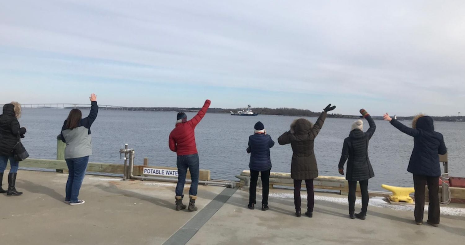 Waving goodbye to the R/V endeavor from a dock at GSO with the Endeavor in the background.
