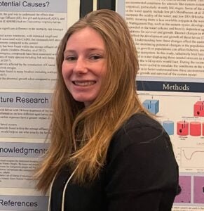 Headshot of Cierra in front of a scientific poster.