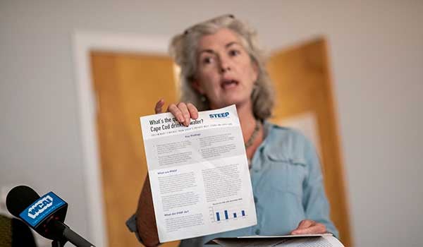 a woman holding up a report