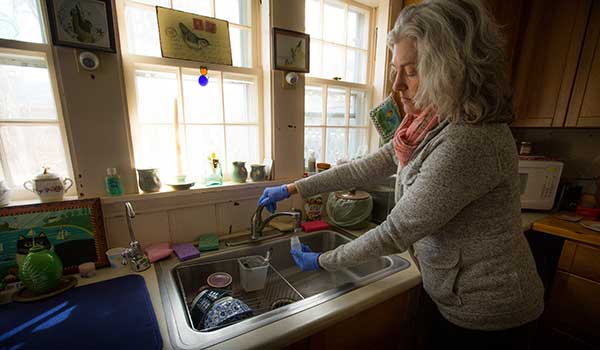 a woman washing dishes