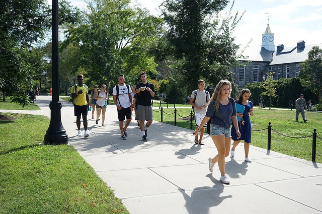 students walking on campus on a sunny day