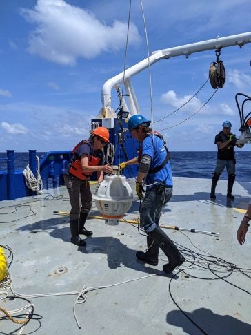 Lowering recovered URI CPIES 110 on to the Pelican's deck