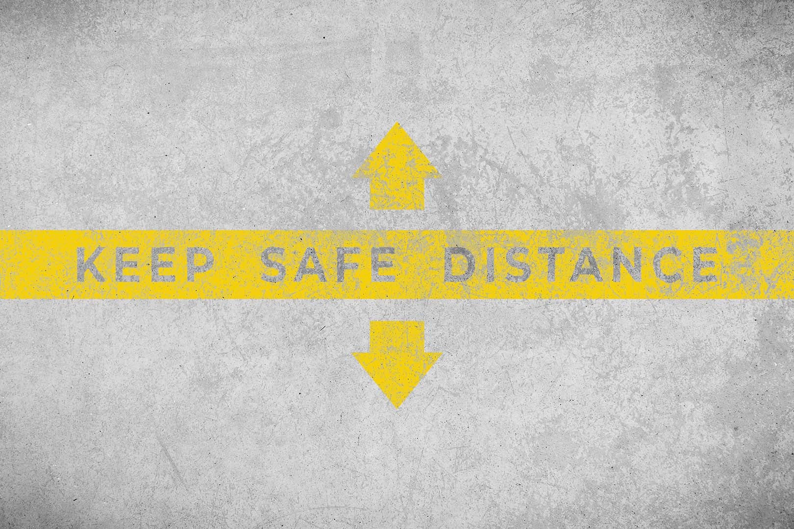Keep safe distance concept. Text painted on aged concrete floor.