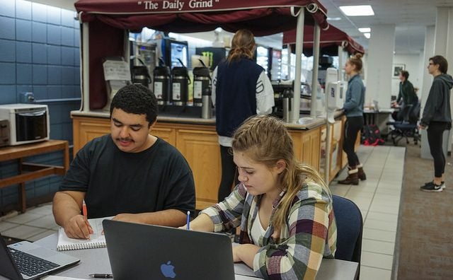 Two students studying in the library 