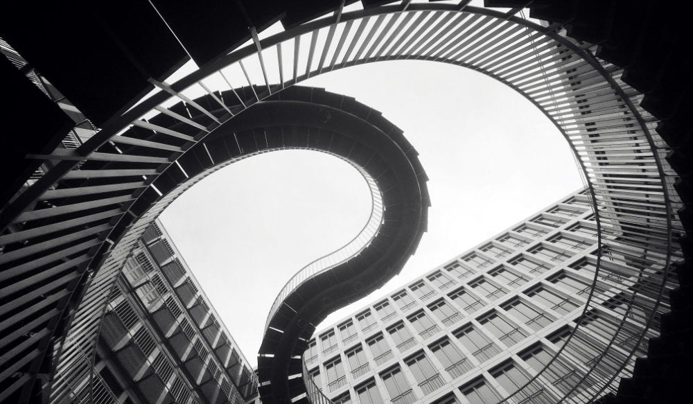 A picture of the Infinite Staircase sculpture in the courtyard of an office building in Munich