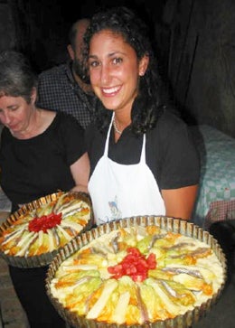 Student holding tray of colorful Greek food