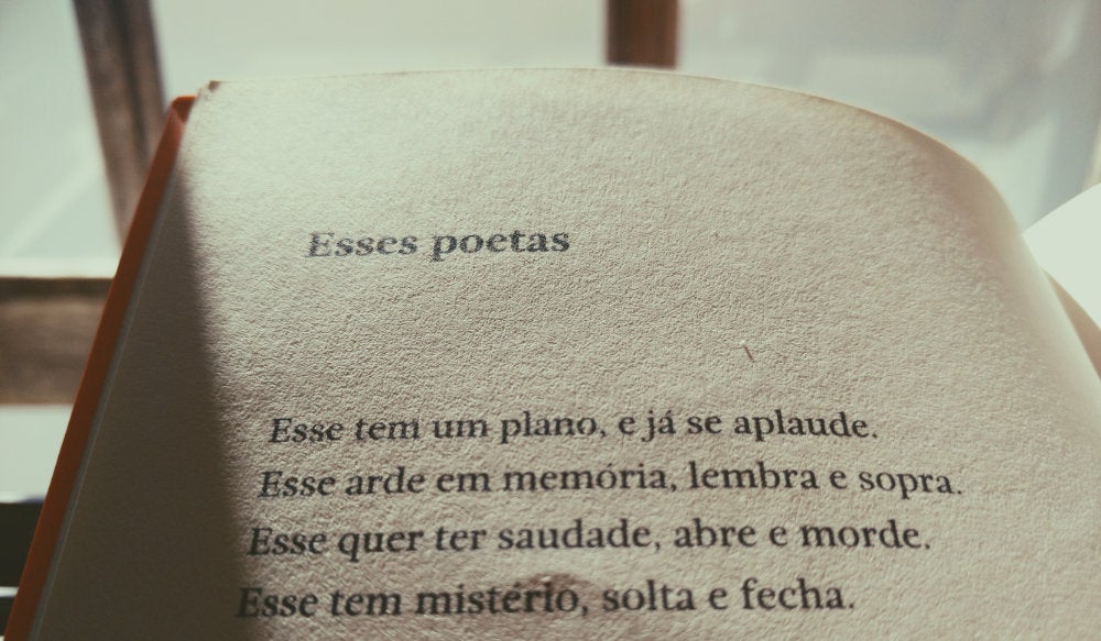 An open book with Portuguese poetry