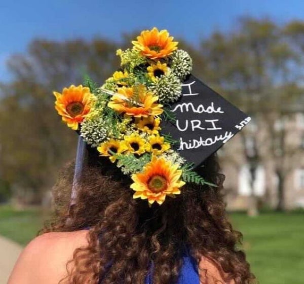 cap decorated with flowers that reads I Made URI History