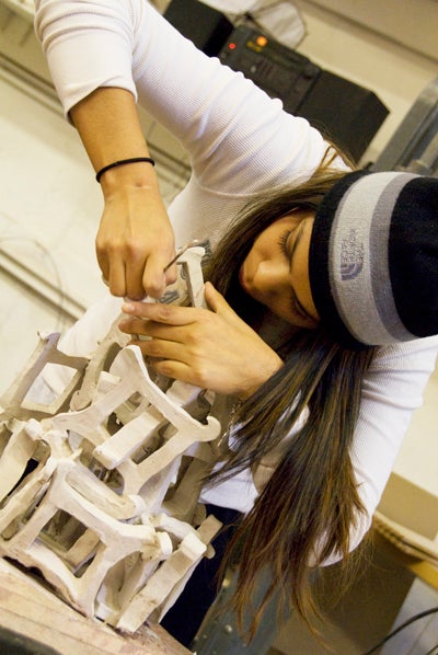 student working on sculpture