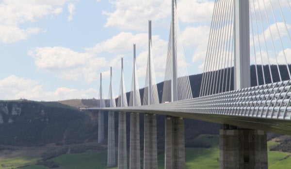 A contemporary bridge spanning a mountainous terrain