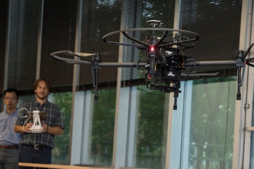professors operate a drone in the AI Lab