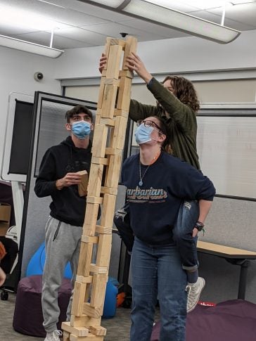 Students stack wooden blocks