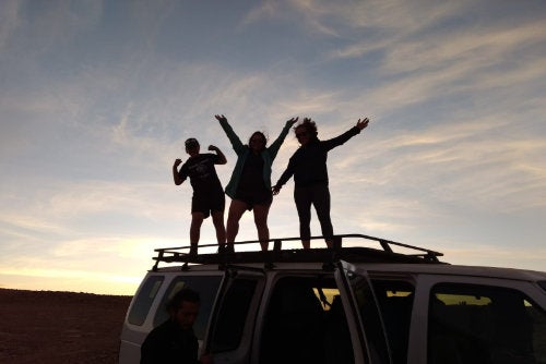 Students enjoy the sunset on the roof of their van during a year abroad in Chile