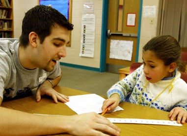 teacher working with young student