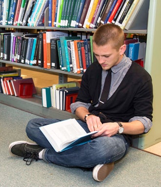 student reading in a library