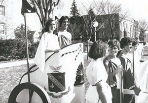 Vintage photo of students in ancient Roman clothing on the quad. Several students are in a chariot.