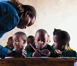 A teacher works with students at Saint Timothy’s.