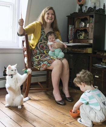 Georgia Dunn ’04, a fine arts graduate, gave up a banking career to follow her passion for illustration. Here, her children Gwen and Luke and cats Elvis and Lupin cluster around her at the desk where she draws each strip by hand. She fits in her work during kiddie nap time and after her husband gets home at night.