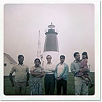 Jhumpa Lahiri with her father, Aman Lahiri (holding her), and family friends in front of the Point Judith lighthouse, early 1970s.