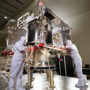 In a clean room at Lockheed Martin, engineers assemble OSIRIS-REx.