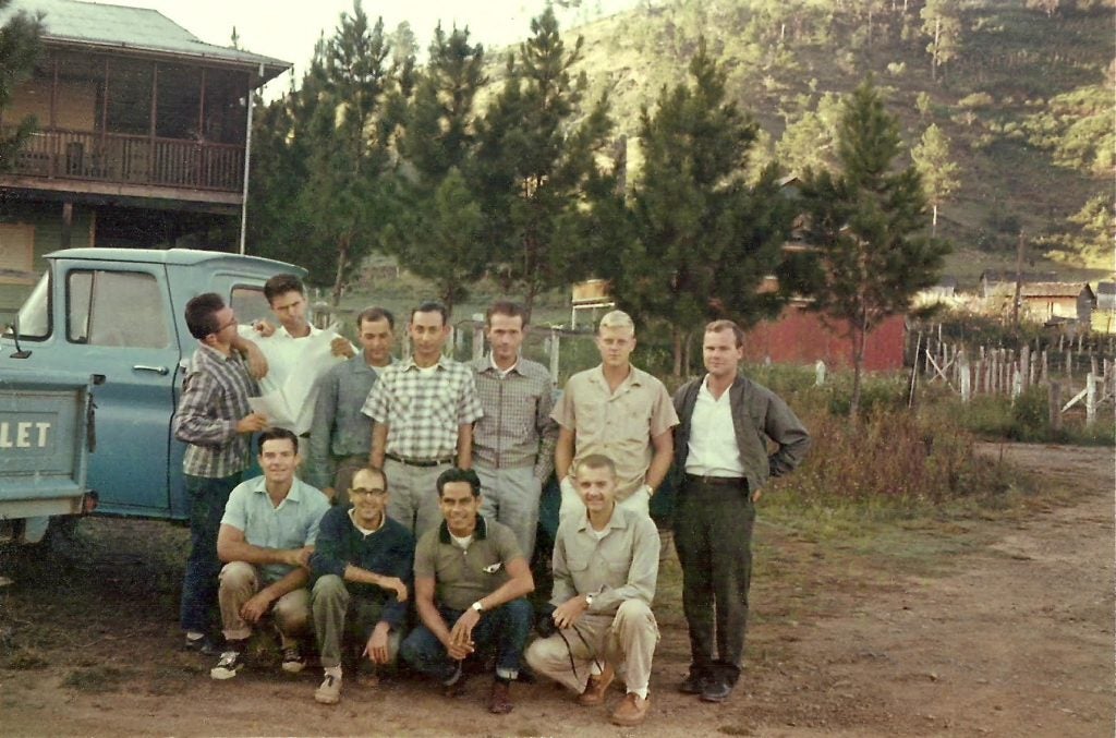 "Golly, how young and handsome."
Neil Ross, alumni coordinator for URI’s Peace Corps prep program,  pictured here with his volunteer forestry group high in the mountains of the Dominican Republic in 1963. (Neil is the in the front row, on the right—the young and handsome guy kneeling with the camera.)