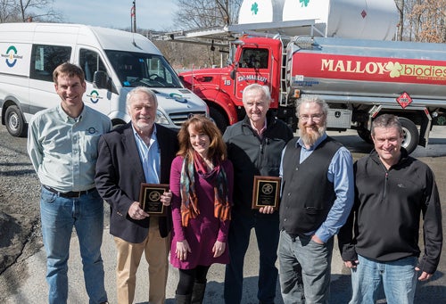 Wendy Lucht (third from left), coordinator of Ocean State Clean Cities Coalition, poses with award winners (l-r) Chris Benzak and Bob Morton of Newport Biodiesel and Tom Malloy Sr., Jim Malloy and Tom Malloy Jr. of Malloy Energy.