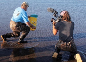 Waders are an essential piece of business equipment for Ayla Fox, here shown shooting footage for an environmentally themed movie at Napatree Point Conservation Area in Westerly, R.I.