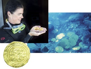 Bridget Buxton, associate professor of archaeology, holds gold coins she retrieved during an underwater archaeological expedition in Israel.