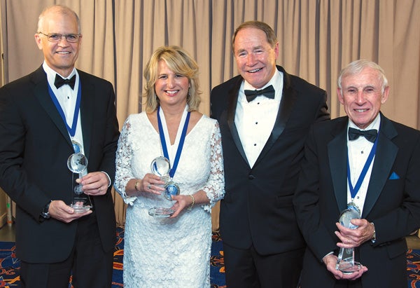 Left to right: Michael Chambrello of IGT, Laurie White ’81, President David M. Dooley and George Graboys, Hon. ’99