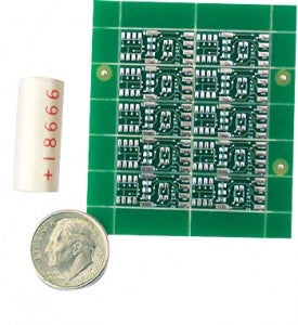 The cylinder that holds the electronics, left, and a set of 10 circuit boards, right, containing the electronics for the fish-tracking device, as compared to a dime.