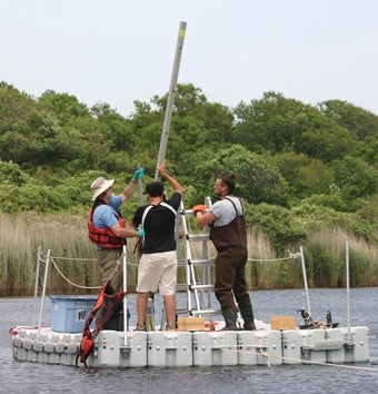 John King and team collecting a core sample of mud and sediment from a kettle pond that was probably part of the Paleolithic landscape.