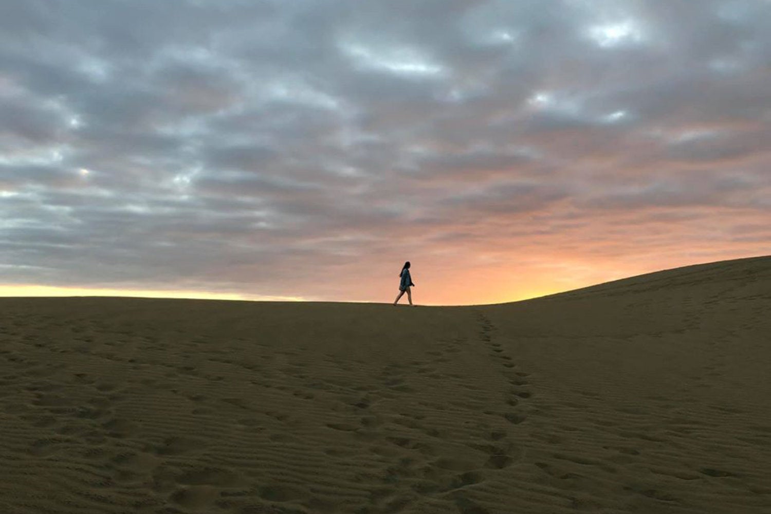 Jenna Ziegelmayer an award recipient walking in a desert landscape in Spain