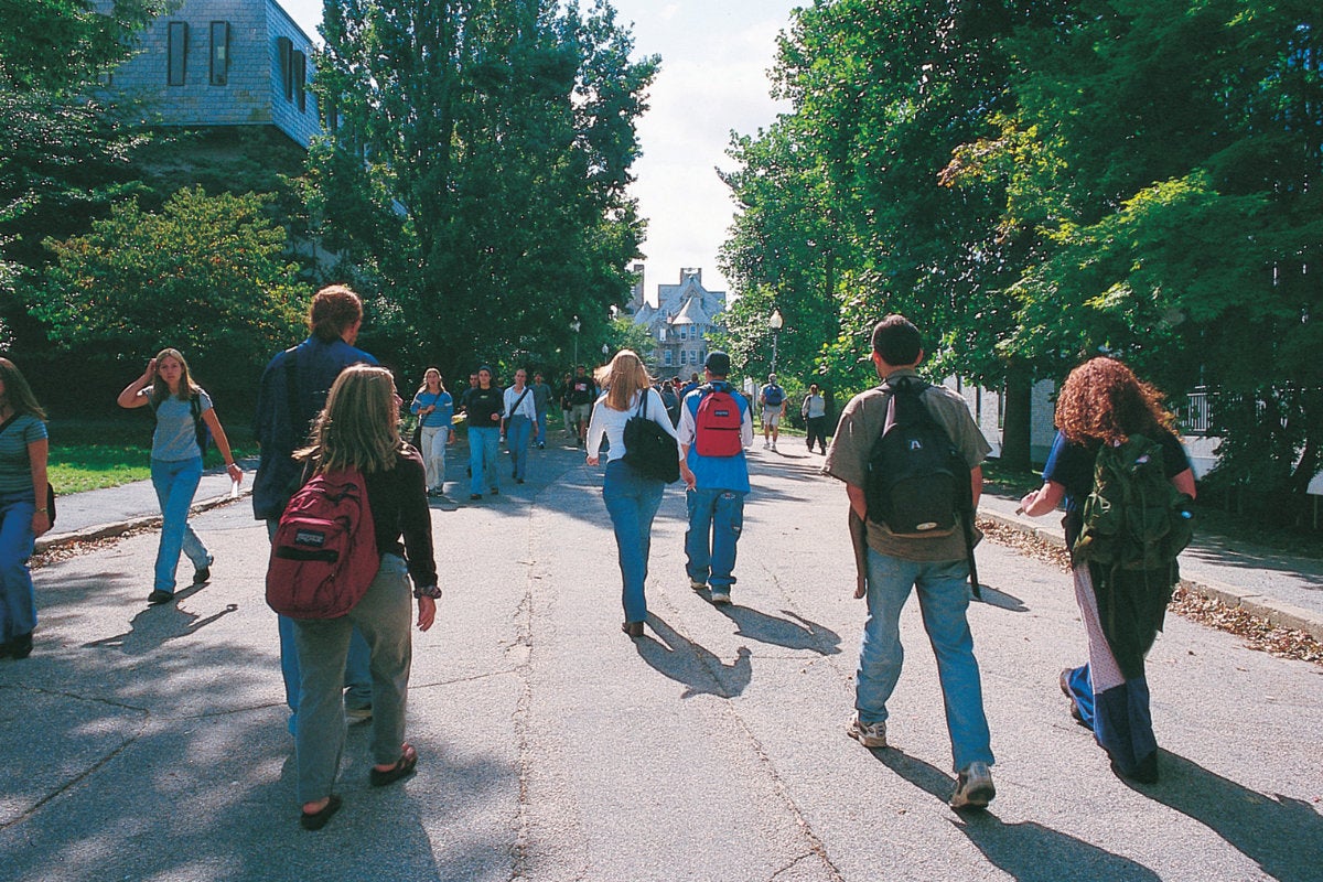 Students walking on a footpath on the URI Kingston campus