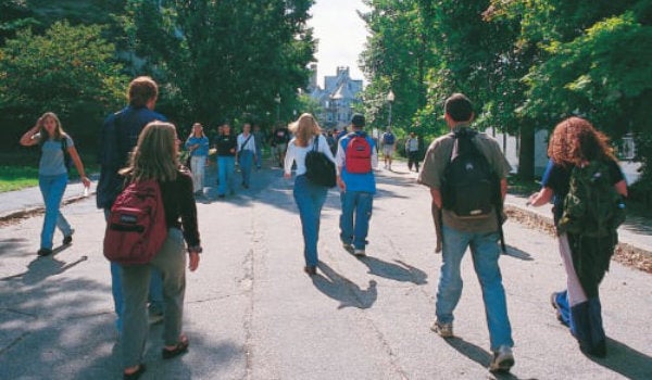 Students from behind on a campus footpath