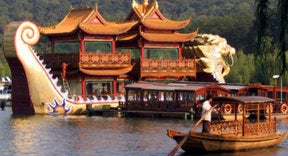 A traditional boat in front of a temple in China