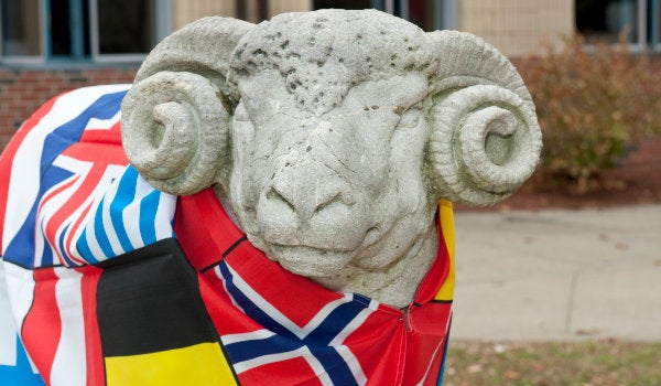The Rhode Island Ram statue draped in flags from several different countries.