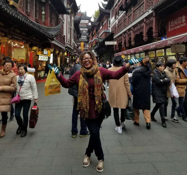 Cynthia Malambi standing in a crowded street in Shanghai