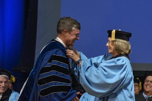 President Parlange receives the URI Presidential Medallion from Chair of the Board of Trustees Margo Cook