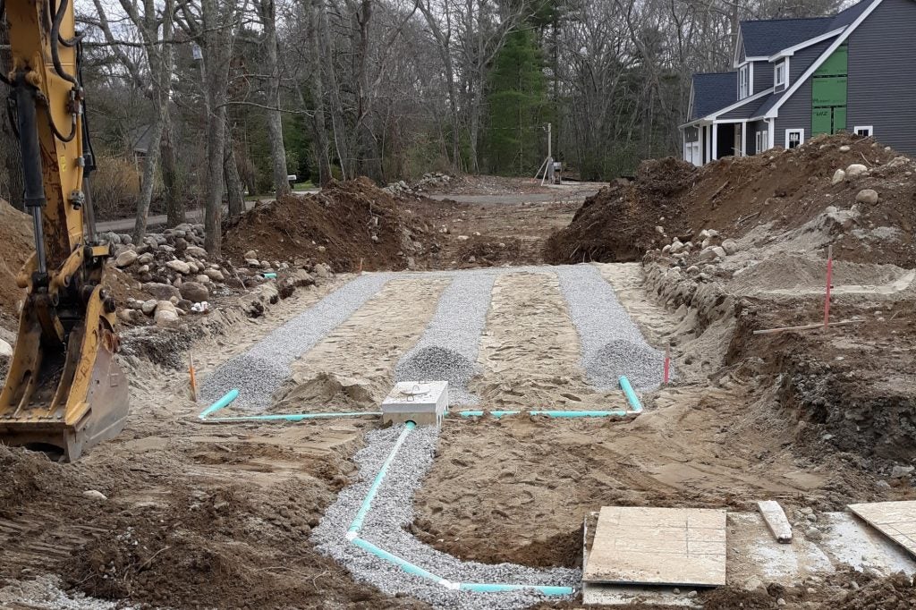 Image showing a partially installed trench drainfield system with distribution box