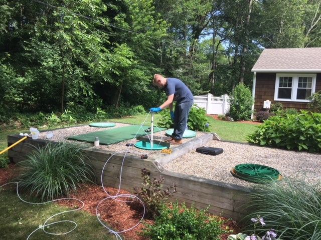 Image of person sampling an advanced treatment septic system technology