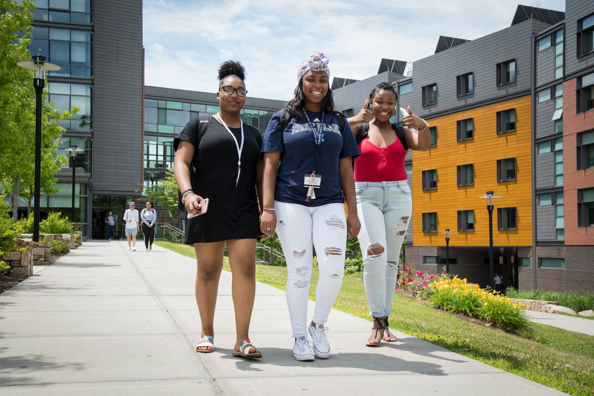 Three Students Walking on Pathway