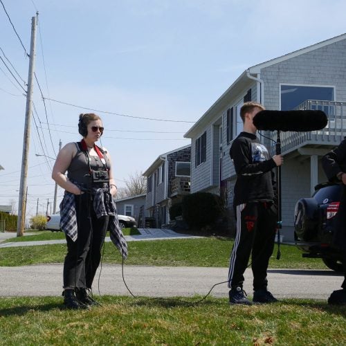 Isobel McCullough listening to recorded audio as she creates the soundscapes of Rhode Island’s beaches