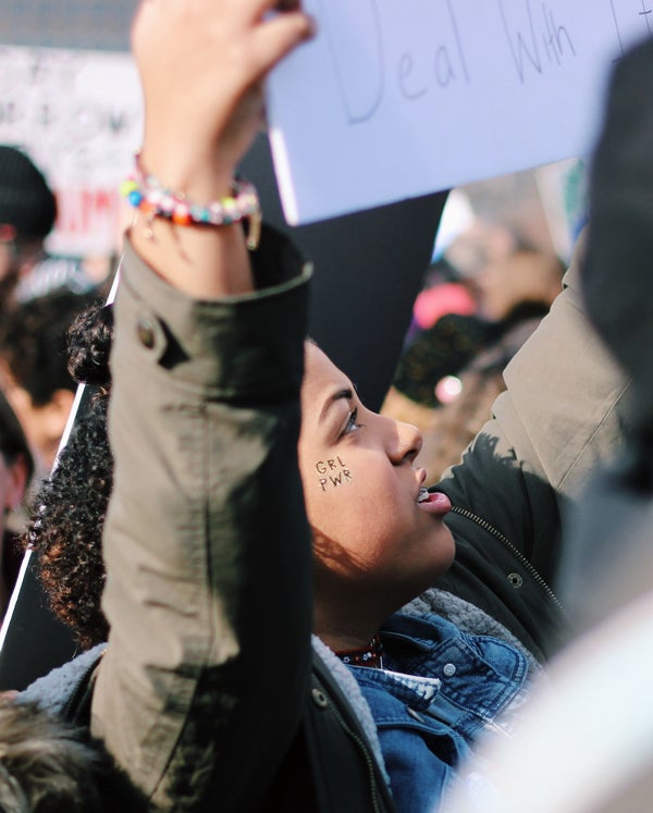 woman holding sign at protest march