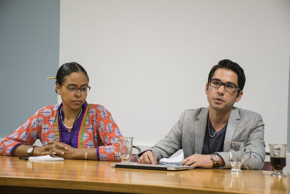 Two professors sitting at a panel discussion during MetLife Institute in 2018