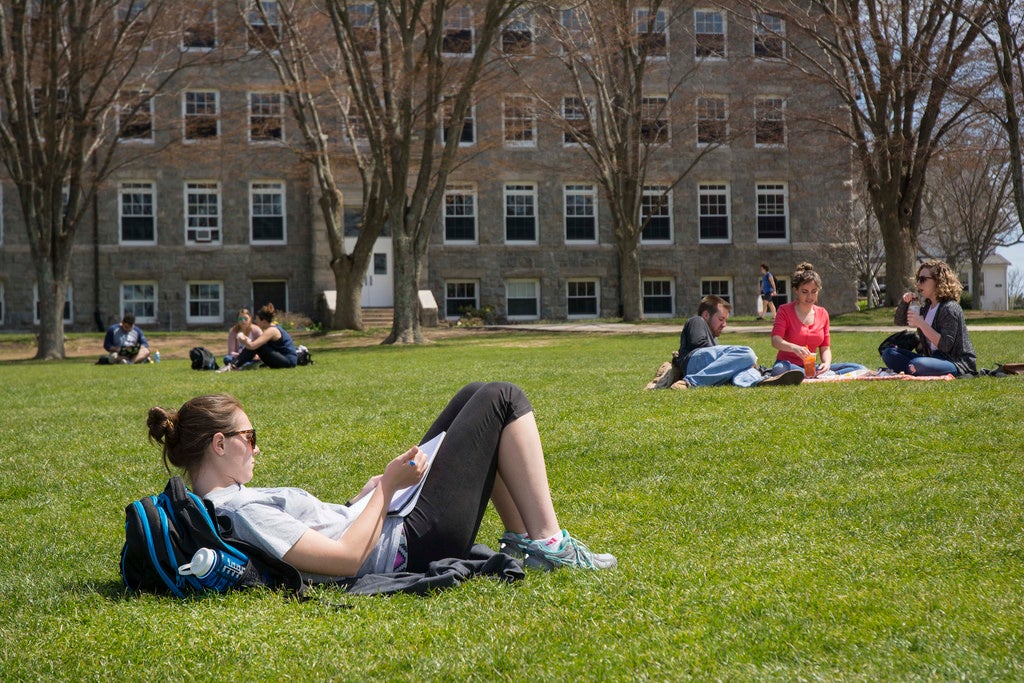 A student studying on the quad