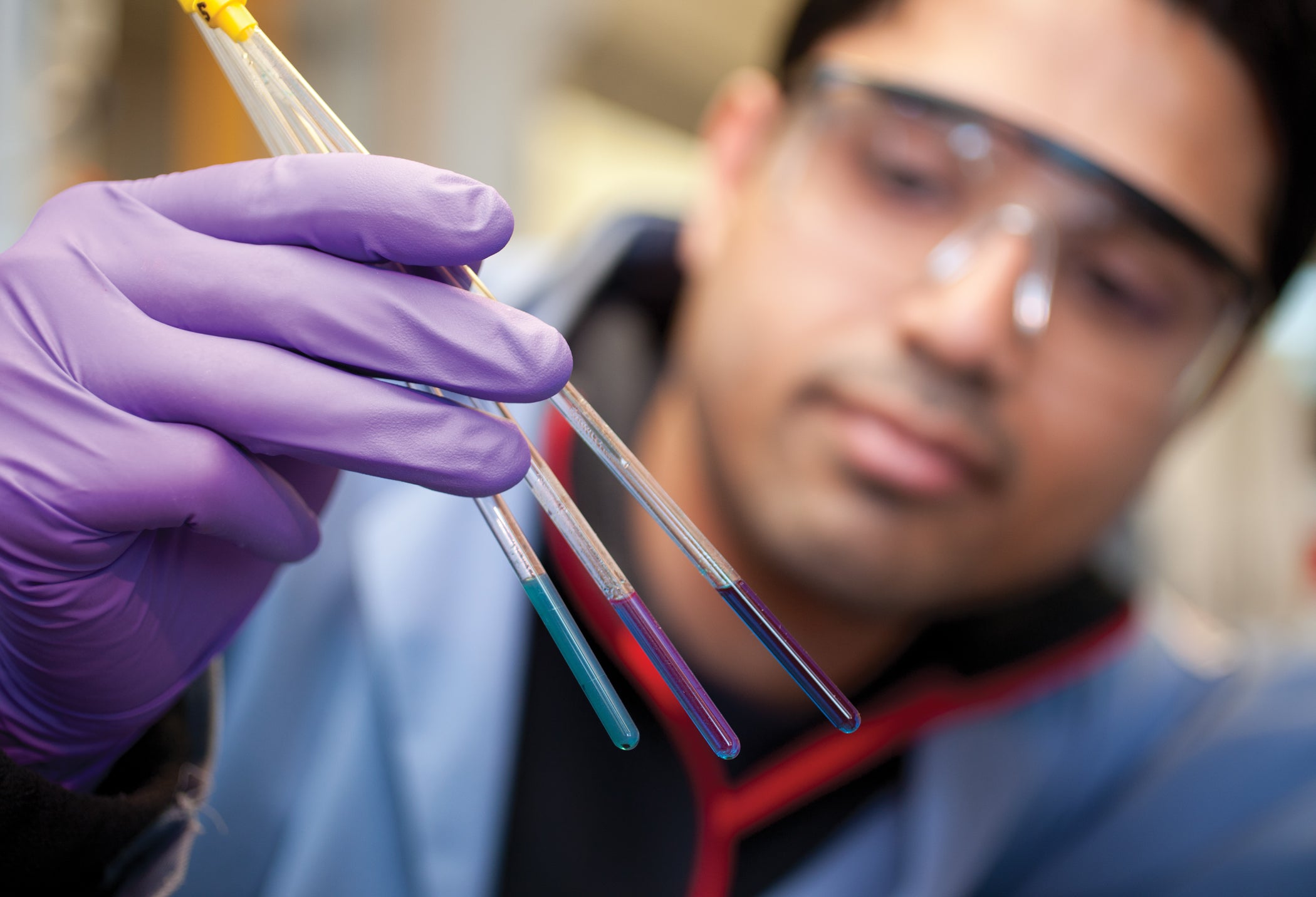 URI Student Sauradip Chaudhuri examining color changes to detect toxic compounds