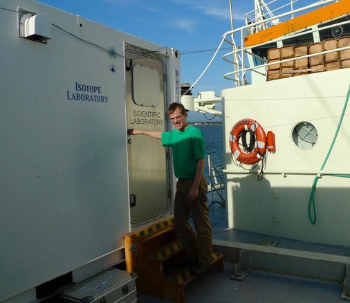 two researchers work inside a van