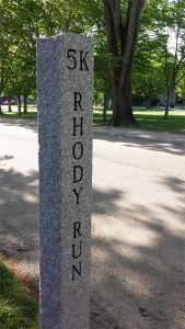 A granite distance marker along the Rhody Run 5K course