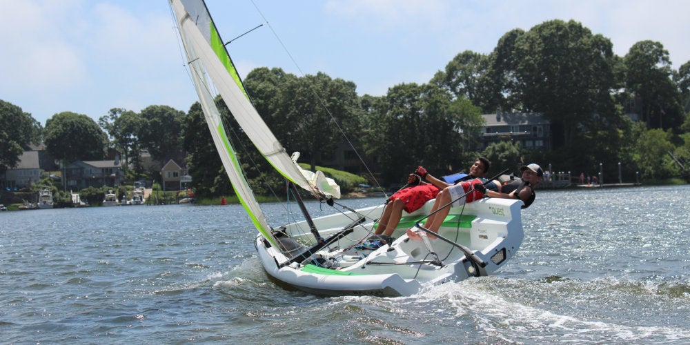Students hiking out during a summer sailing program